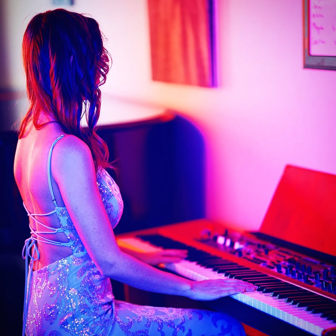 Awake & Dreaming Sasha Kristoff posing with piano